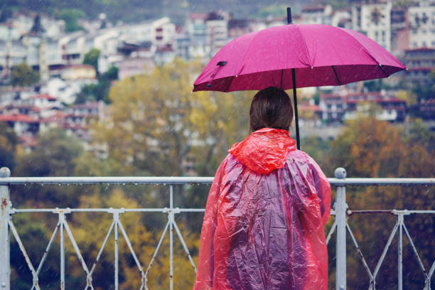 istock Woman standing in the rain 1283917598