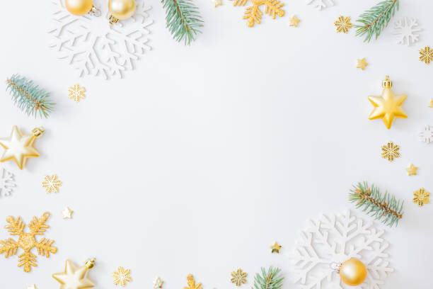istock Flat lay frame with fir branches, christmas baubles decoration and snowflakes on a white background 1283918041