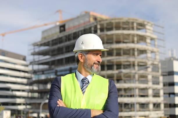 istock Senior manager - portrait in front of an office building under construction 1283918542
