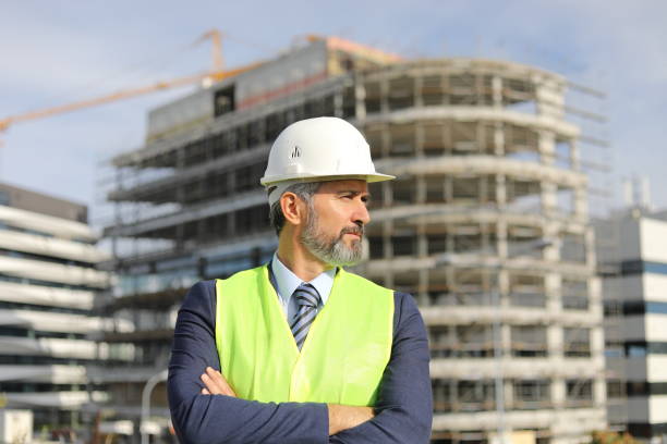 istock Senior manager - portrait in front of an office building under construction 1283918593