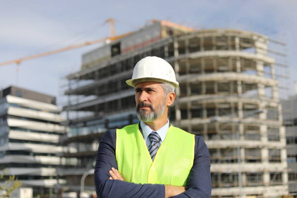 istock Senior manager - portrait in front of an office building under construction 1283918639