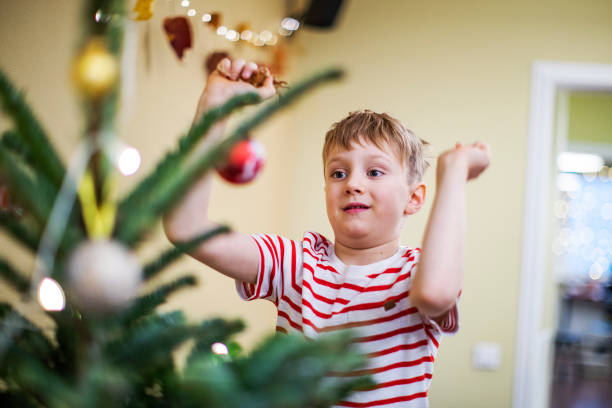 istock Father and son decorating the Christmas tree 1283919182