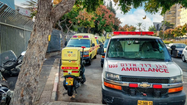 Car-filled parking lot in front of an ambulance station in the city Rishon LeTsiyon Rishon LeTsiyon, Israel-November 2, 2020: One special motorcycle is visible among the ambulances. It is also equipped with everything necessary to provide emergency assistance. This station is located at Jabotinsky Street 104 ambulance in israel stock pictures, royalty-free photos & images