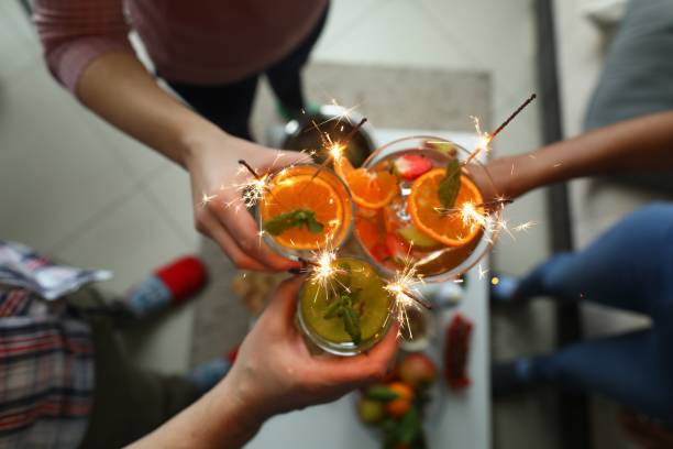 istock Alcoholic cocktails with sparklers in hands 1283919468