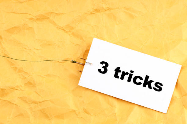 istock paper on a fish hook with 3 tricks written on it 1283920665