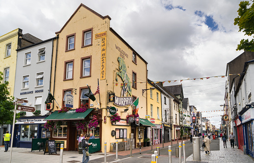 View of a street in the touristy Irish town of Cork with a pub in the foreground.