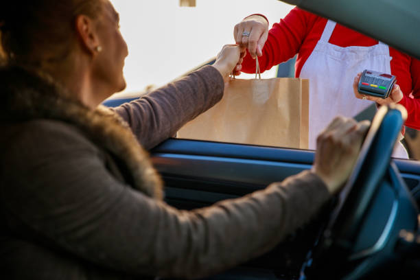istock Getting her takeaway food from the car 1283921618