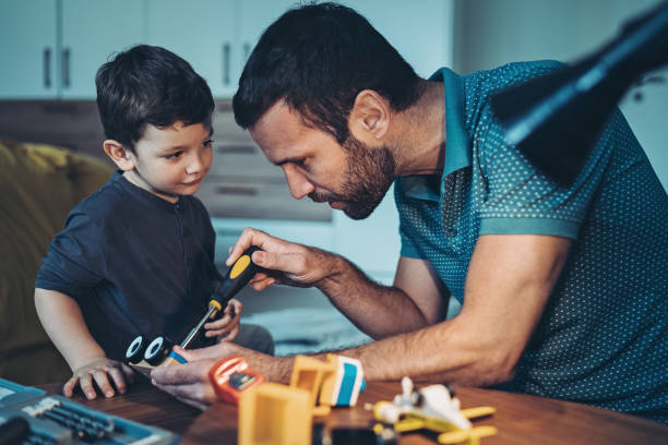 istock Father assembling a toy for his little son 1283924442
