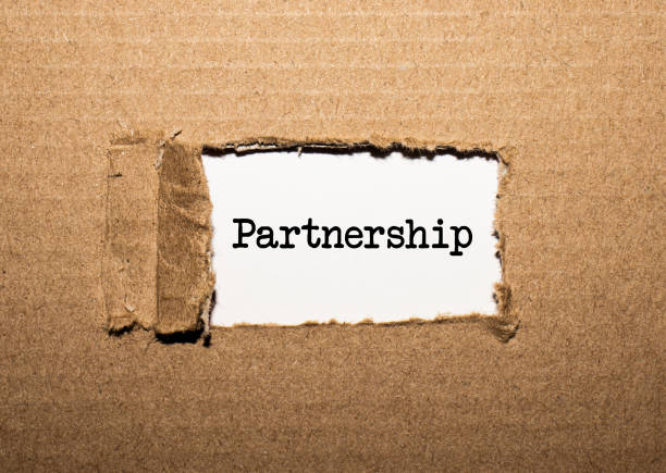 istock The text PARTNERSHIP. behind torn brown paper 1283925540