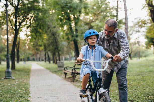istock boy with his grandfather in public park 1283926513