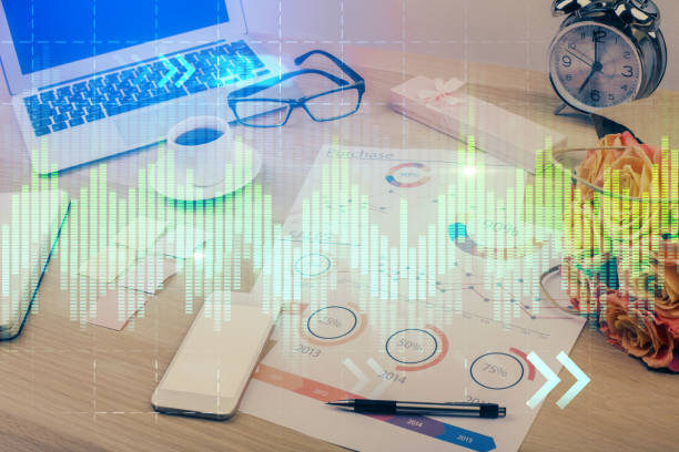 istock Financial graph colorful drawing and table with computer on background. Multi exposure. Concept of international markets. 1283930790