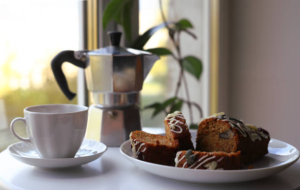 istock White mug with coffee, coffee pot and muffin with nuts. 1283931491