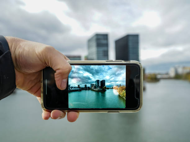 Picture of taking a photo of Media Harbour, Düsseldorf A picture of me taking a mobile photo from the cityscape of Medienhafen taken on mobile device stock pictures, royalty-free photos & images
