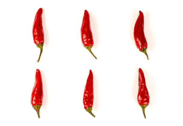A group of several red hot peppers on a light background. Close-up. Spice. Vegetarianism