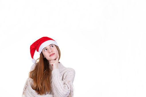 Cheerful young woman in red dress santa holding gift box for christmas isolated on white background.