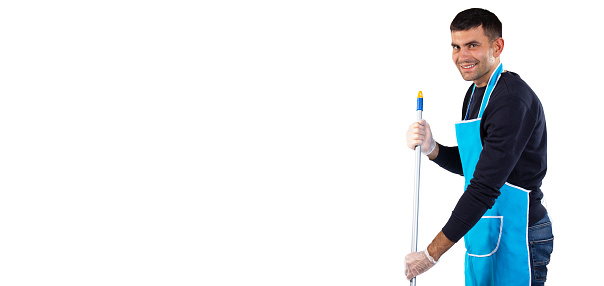 Banner, long format. A man in an apron mops the floor with a mop and smiles at the camera. Photo on white background with empty side space. High quality photo