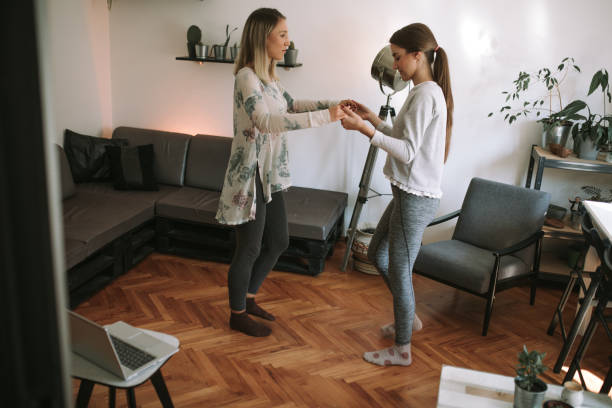 istock Female siblings are dancing at home and having fun. 1283939384