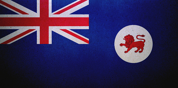 Flag of the British Overseas Territory of the South Georgia and the South Sandwich Islands on a textured background. Concept collage.