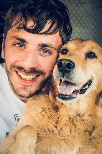 istock Young Man And Golden Retriever 1283939537