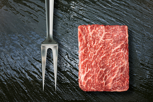 Kobe beef filet marbled meat on black shale\nKuroge Washu is unique in the beef world, and in the entire animal kingdom, for its genetic predisposition to developing fine-grained, speckled fat marbling inside the meat itself.
