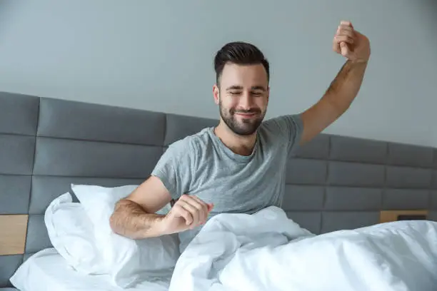 Photo of Bachelor man daily routine single lifestyle morning concept awakening gymnastic