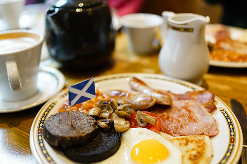 English full breakfast actually Scotish brunch with Scottish flag on black pudding