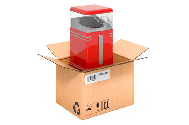istock Popcorn maker inside cardboard box, delivery concept. 3D rendering isolated on white background 1283943987