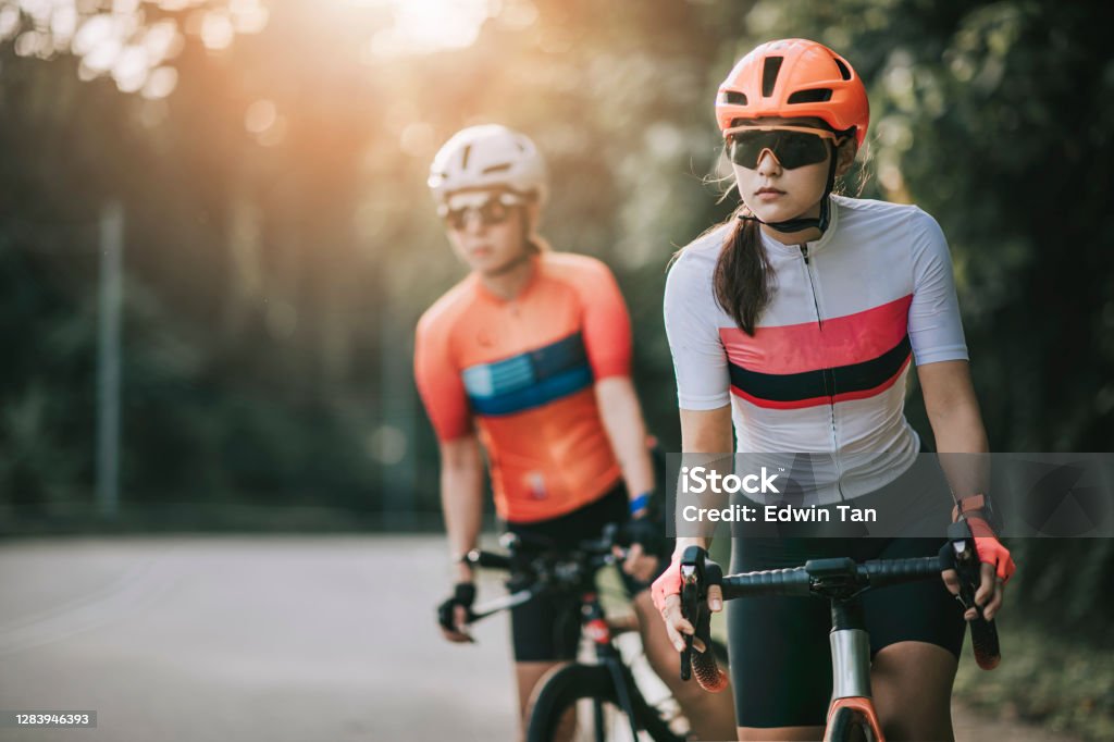 2 asian chinese woman road bike cyclist cycling in rural area in the morning getting ready to cycle 2 asian chinese woman road bike cyclist cycling in rural area in the morning Cycling Stock Photo