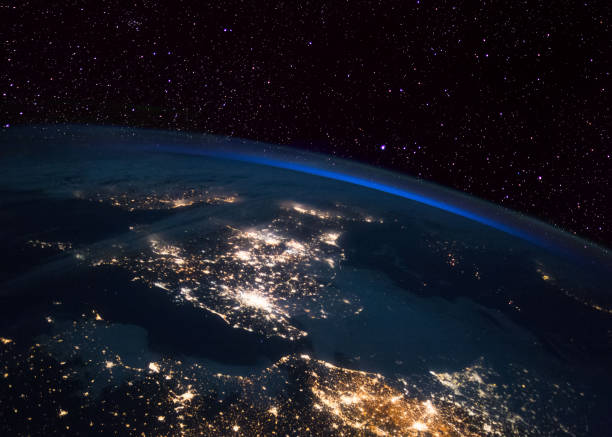 The UK at night from the International Space Station (ISS). France and Holland in the foreground. Elements of this image furnished by NASA. international space station photos stock pictures, royalty-free photos & images