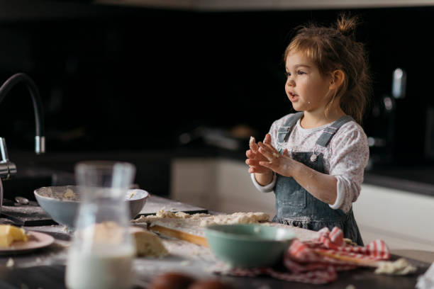 istock Young playful Caucasian girl playing Chef in her kitchen 1283947590