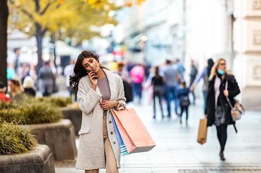 Woman in shopping. Happy woman with shopping bags enjoying in shopping. Consumerism, shopping, lifestyle concept