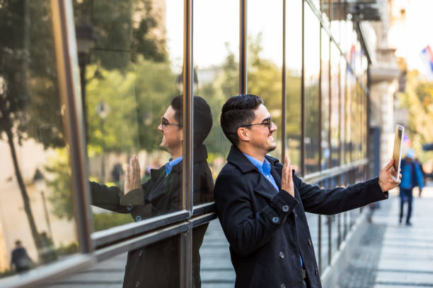 istock Young Business man using his tablet  on the street. 1283949843