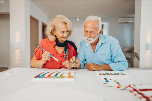 Senior couple painting together