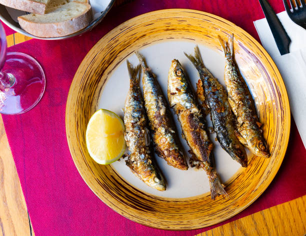 istock Deliciously  fried  many sardines served with lemon at plate 1283953492