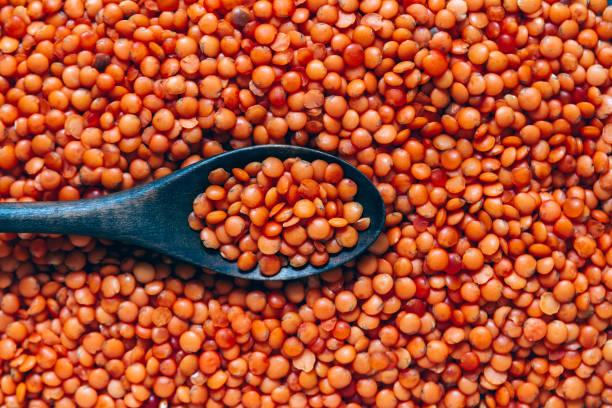 istock Wooden spoon in red lentils, food background 1283954049
