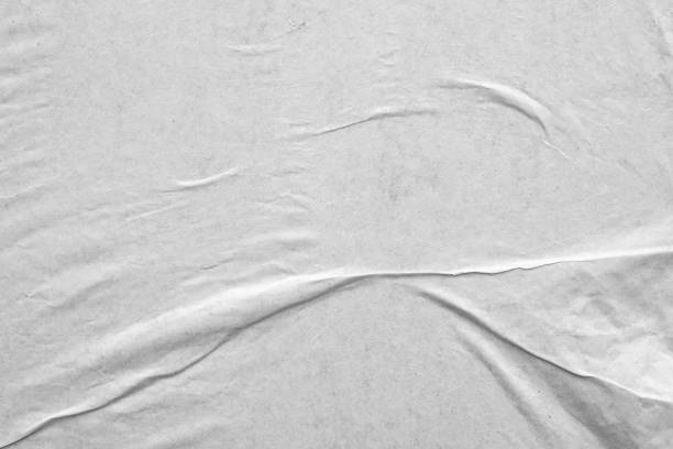 istock Blank white crumpled and creased paper poster texture background 1283954942