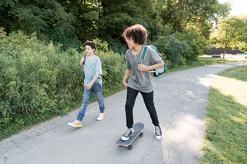 Friends skateboarding to school
