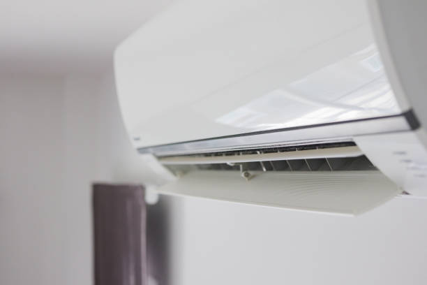 istock Air conditioner on white wall room interior background 1283954991