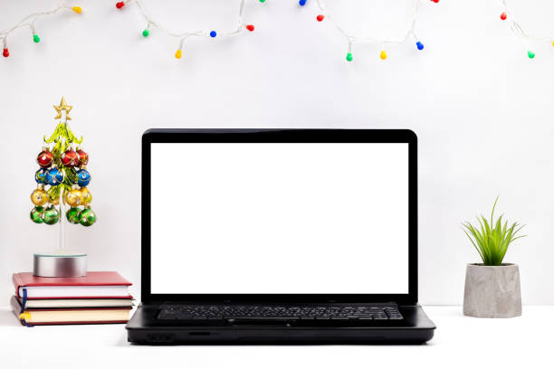 istock side view for a christmas workplace at office or home office. white laptop display mockup. template for christmas card 1283961549
