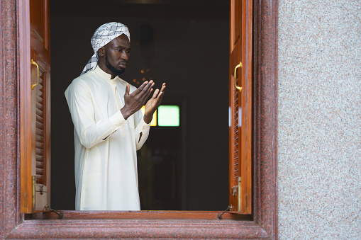 muslim man having worship and praying for allah blessing in islam ceremony in mosque during islamic ramadan period