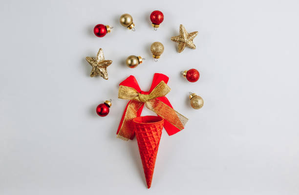 istock Ice Cream Waffle Cone with Christmas baubles on white background. Top view. Flat lay 1283964456