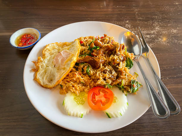 istock Rice topped with stir-fried Stewed Pork and basil with fried egg 1283965346