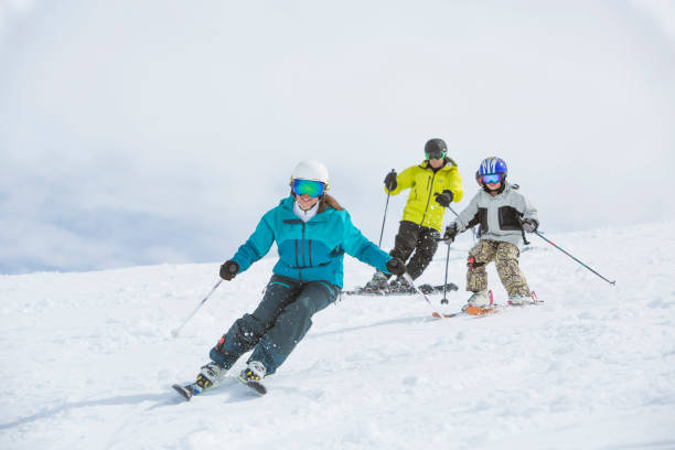 Family on ski vacation in Whistler, BC, Canada. Family skiing together on sunny day. skiing photos stock pictures, royalty-free photos & images