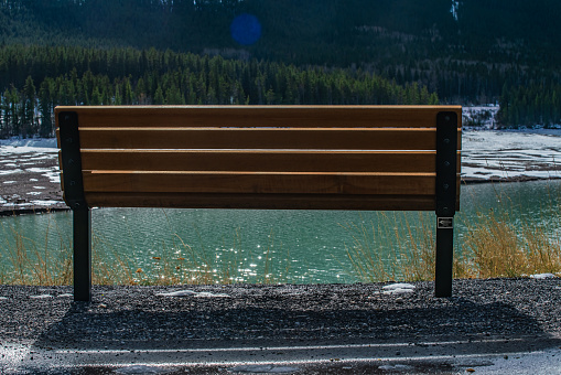 Park Bench Overlooking Barrier Lake and the Rocky Mountains in the Background - Alberta, Canada