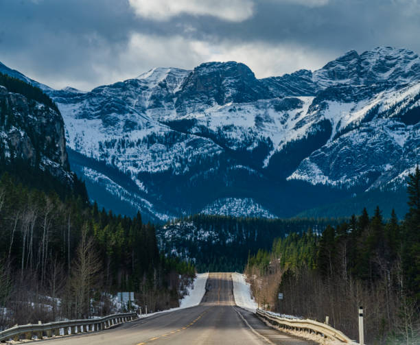 istock Single Lane Highway Going through the Rocky Mountains 1283970962