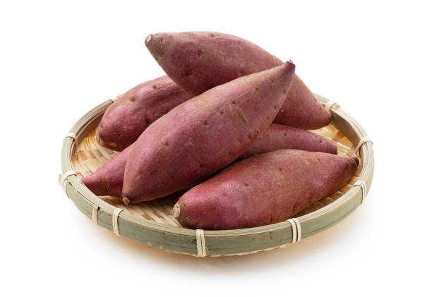 Sweet potatoes in a colander on a white background