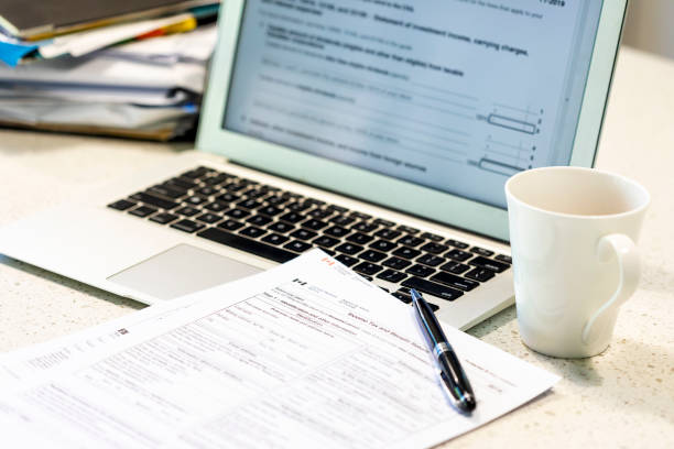 istock Laptop Computer with Income Tax Documents for Canada 1283977103
