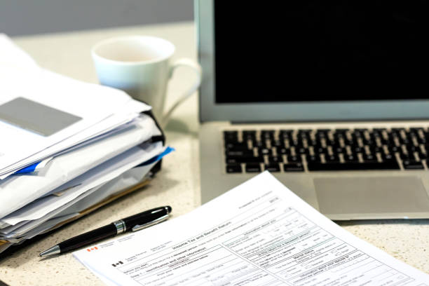 istock Laptop Computer with Income Tax Documents for Canada 1283977754