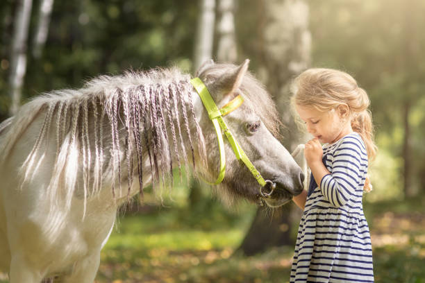 istock Little blond girl with pony 1283979500