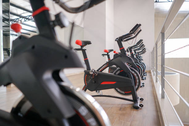 exercising bike at indoor gym in a row exercising bike at indoor gym in a row exercise bike stock pictures, royalty-free photos & images